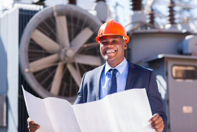 electrical manager holding blueprint in electric substation